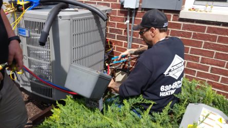 Photo of Ted from Tritan Services repairing an air conditioner
