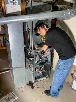 Photo of Tritan Services repairing a furnace